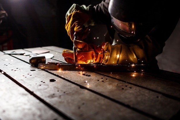 A man is using a plasma cutter.