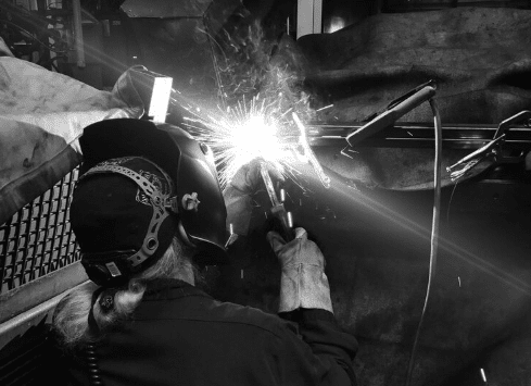 Automotive welder wearing protective equipment to ensure welding safety3