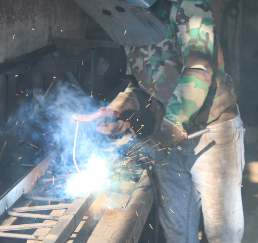 Workers are using stick welders to weld aluminum products.