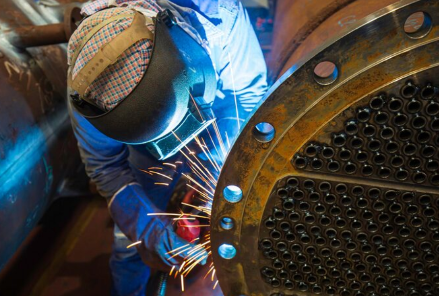 Because the male worker is welding a large product with MIG Weld with Flux Core Wire